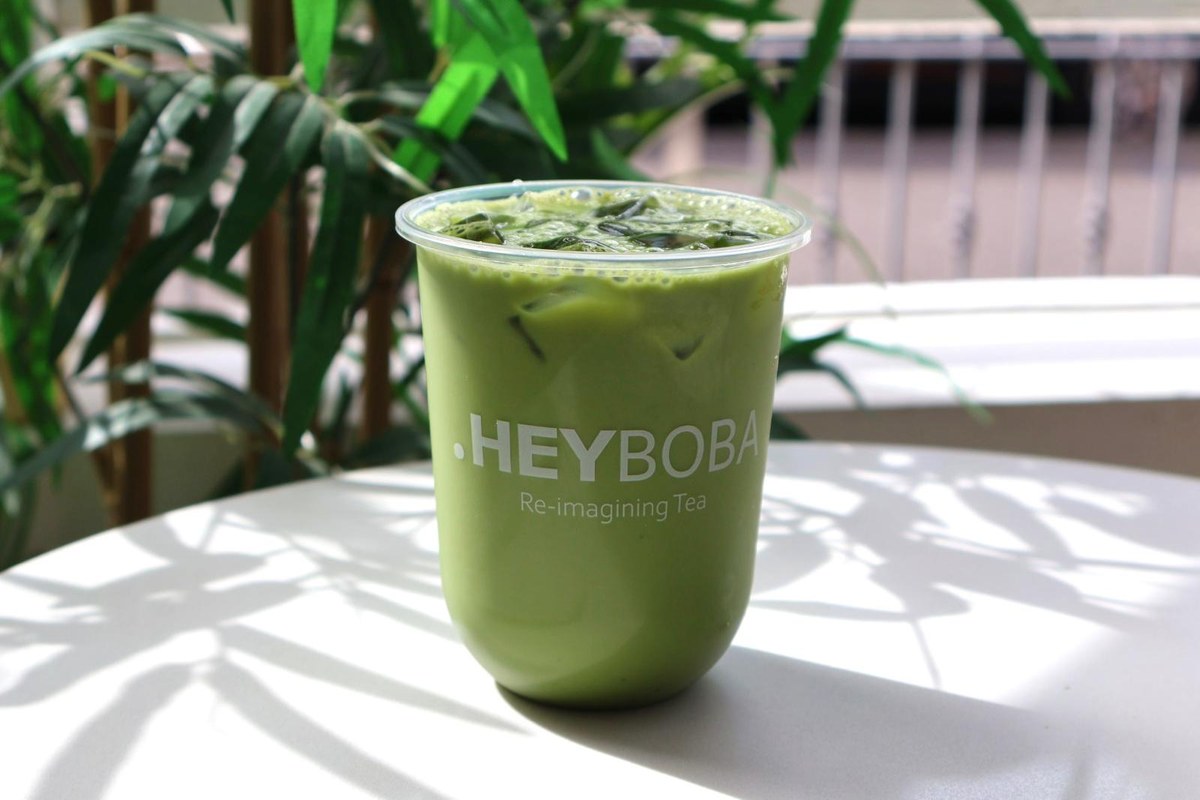 Iced HEYBOBA matcha on a sunlit table